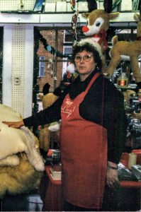 Shirley Evert working at The Corner News Store in Millbrook, New York at Christmas time
